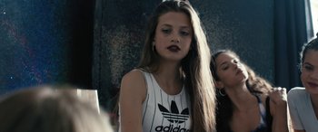 Movie still from “Blue My Mind” (2017), directed by Lisa Brühlmann – A woman with long brown hair wearing a black and white adidas shirt; Close Up shot, Over the shoulder angle