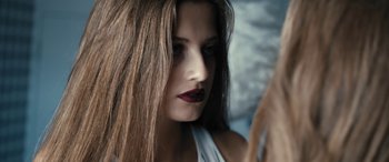 Movie still from “Blue My Mind” (2017), directed by Lisa Brühlmann – A person with long brown hair; Close Up shot, Over the shoulder angle