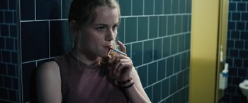 A woman holding a toothbrush in her mouth