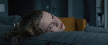 A person laying on a couch