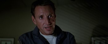 Movie still from “Blue Thunder” (1983), directed by John Badham – A person wearing a jacket looking at the camera; Close Up shot, Low angle