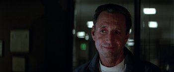 Movie still from “Blue Thunder” (1983), directed by John Badham – A person wearing a jacket; Close Up shot, Over the shoulder angle