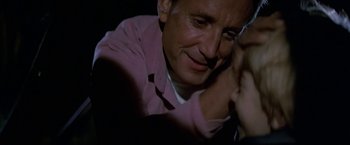 Movie still from “Blue Thunder” (1983), directed by John Badham – A person sitting in front of a window; Close Up shot, Over the shoulder angle