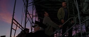 Movie still from “Blue Thunder” (1983), directed by John Badham – A man standing on top of a metal structure; Medium shot, Low angle