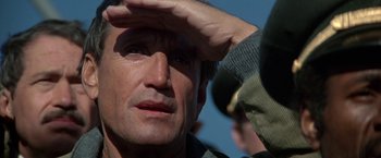 Movie still from “Blue Thunder” (1983), directed by John Badham – A man's face as he looks into the distance; Close Up shot, Low angle