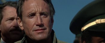 Movie still from “Blue Thunder” (1983), directed by John Badham – A man's face in the sunlight; Close Up shot, Low angle