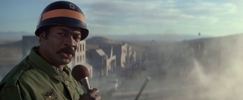 A man holding a microphone in front of a city