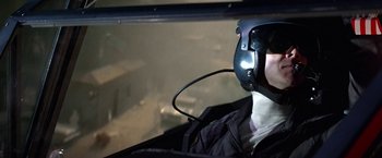 Movie still from “Blue Thunder” (1983), directed by John Badham – A person wearing a helmet and goggles in a helicopter cockpit; Close Up shot, Low angle