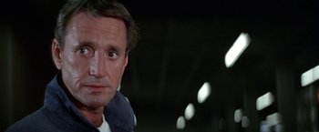 Movie still from “Blue Thunder” (1983), directed by John Badham – A man's face in the dark; Close Up shot, Low angle