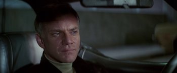 Movie still from “Blue Thunder” (1983), directed by John Badham – A person sitting in a car; Close Up shot, Low angle