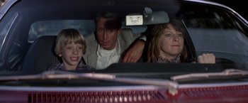 Movie still from “Blue Thunder” (1983), directed by John Badham – A man and two women in a car; Close Up shot, Over the shoulder angle