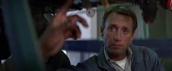 Movie still from “Blue Thunder” (1983), directed by John Badham – A person sitting in a car; Close Up shot, Low angle