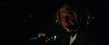 Movie still from “Blue Thunder” (1983), directed by John Badham – A man in a suit wearing a helmet; Close Up shot, Low angle
