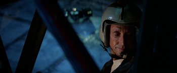 Movie still from “Blue Thunder” (1983), directed by John Badham – A person wearing a helmet; Close Up shot, Low angle