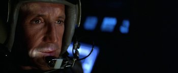 Movie still from “Blue Thunder” (1983), directed by John Badham – A person wearing a helmet; Close Up shot, Low angle