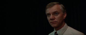 Movie still from “Blue Thunder” (1983), directed by John Badham – A person wearing a suit and tie; Close Up shot, Low angle