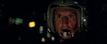 Movie still from “Blue Thunder” (1983), directed by John Badham – A person wearing a helmet; Close Up shot, Low angle