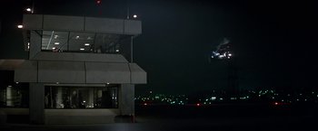 Movie still from “Blue Thunder” (1983), directed by John Badham – An airplane is flying in the sky at night; Extreme Wide shot, Low angle