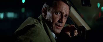 Movie still from “Blue Thunder” (1983), directed by John Badham – A person wearing a suit and tie; Close Up shot, Low angle