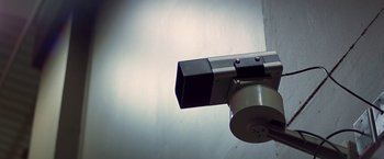 Movie still from “Blue Thunder” (1983), directed by John Badham – A camera on the ceiling of a building; Extreme Close Up shot, Low angle