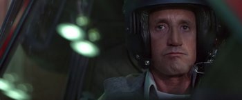 Movie still from “Blue Thunder” (1983), directed by John Badham – A person wearing a helmet; Close Up shot, Low angle