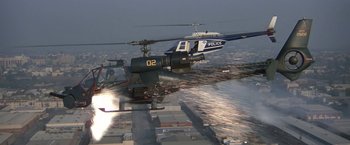 Movie still from “Blue Thunder” (1983), directed by John Badham – Two police helicopters flying over a city with buildings in the background; Extreme Wide shot, High angle