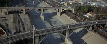 Movie still from “Blue Thunder” (1983), directed by John Badham – An aerial view of an overpass with cars driving on it; Extreme Wide shot, High angle