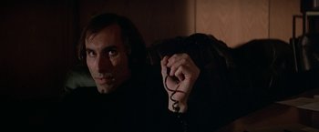 Movie still from “Blue Thunder” (1983), directed by John Badham – A man holding a phone in his hand; Close Up shot, Low angle