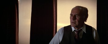 Movie still from “Blue Thunder” (1983), directed by John Badham – An older man wearing a vest and a tie; Close Up shot, Low angle