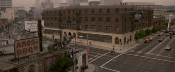 Movie still from “Blue Thunder” (1983), directed by John Badham – Two people on a bike on a city street; Extreme Wide shot, High angle
