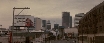 Movie still from “Blue Thunder” (1983), directed by John Badham – A view of a city skyline from a distance; Extreme Wide shot, Low angle
