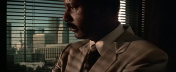 Movie still from “Blue Thunder” (1983), directed by John Badham – A person wearing a suit and tie; Close Up shot, Low angle