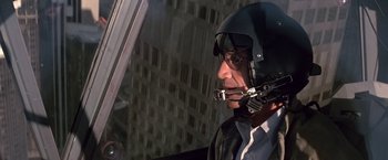 Movie still from “Blue Thunder” (1983), directed by John Badham – A man in a helicopter wearing a helmet; Medium shot, Low angle