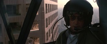 Movie still from “Blue Thunder” (1983), directed by John Badham – A man in a helicopter looking out of a window; Close Up shot, Over the shoulder angle