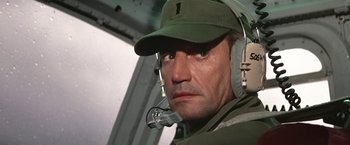 Movie still from “Blue Thunder” (1983), directed by John Badham – A person wearing a hat and ear muffs; Close Up shot, Low angle