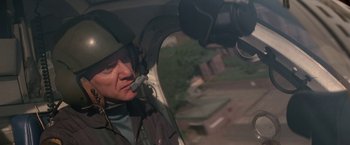 Movie still from “Blue Thunder” (1983), directed by John Badham – A man in a helicopter looking out of the window; Close Up shot, Over the shoulder angle
