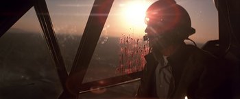 Movie still from “Blue Thunder” (1983), directed by John Badham – A man looking out of a window at sunset; Close Up shot, Low angle