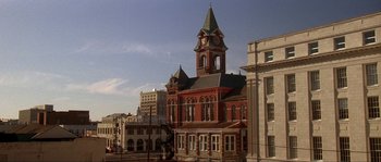 Movie still from “Blue Velvet” (1986), directed by David Lynch – An old red building with a clock on the top of it; Extreme Wide shot, Low angle