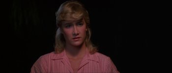 Movie still from “Blue Velvet” (1986), directed by David Lynch – A woman with blonde hair wearing a pink striped shirt; Close Up shot, Over the shoulder angle