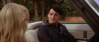 Movie still from “Blue Velvet” (1986), directed by David Lynch – A man sitting in the back seat of a car; Close Up shot, Over the shoulder angle