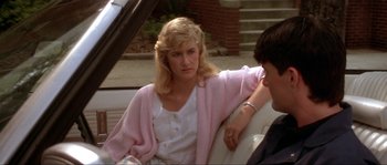 Movie still from “Blue Velvet” (1986), directed by David Lynch – A woman sitting in the back seat of a car; Close Up shot, Over the shoulder angle