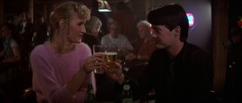 Movie still from “Blue Velvet” (1986), directed by David Lynch – A man and a woman drinking beer at a bar; Medium shot, Over the shoulder angle
