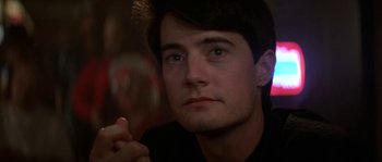 Movie still from “Blue Velvet” (1986), directed by David Lynch – A person looking at the camera; Close Up shot, Over the shoulder angle