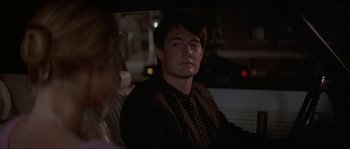 Movie still from “Blue Velvet” (1986), directed by David Lynch – A man sitting in the back seat of a car at night; Close Up shot, Over the shoulder angle