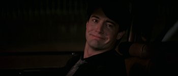 Movie still from “Blue Velvet” (1986), directed by David Lynch – A person wearing a suit and tie; Close Up shot, Over the shoulder angle