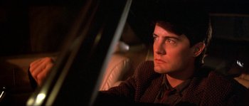 Movie still from “Blue Velvet” (1986), directed by David Lynch – A person sitting in a car; Close Up shot, Over the shoulder angle