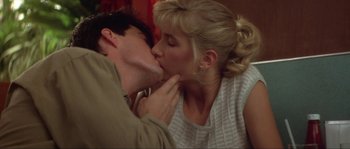 Movie still from “Blue Velvet” (1986), directed by David Lynch – A man and a woman kissing on a couch; Close Up shot, Low angle