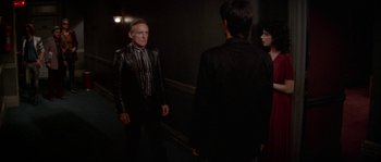 Movie still from “Blue Velvet” (1986), directed by David Lynch – A group of people standing in a room; Medium shot, Over the shoulder angle