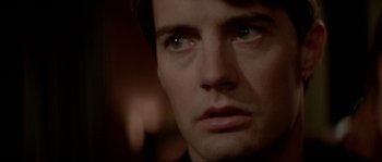 Movie still from “Blue Velvet” (1986), directed by David Lynch – A man's face in a dark room; Close Up shot, Over the shoulder angle