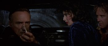 Movie still from “Blue Velvet” (1986), directed by David Lynch – A woman is sitting in the driver's seat of a car; Close Up shot, Over the shoulder angle